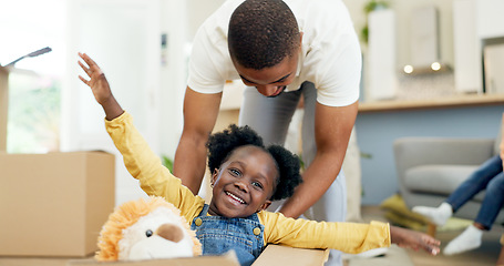 Image showing Father, child and playing in a box while moving house with a black family together in a living room. Man and a girl kid excited about fun game in their new home with a smile, happiness and adventure
