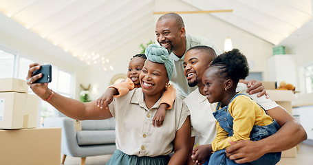 Image showing Moving, happy family and selfie with kids in new home, boxes and people in living room of house. African mother, father and children in self portrait with boxes, real estate and happy investment.