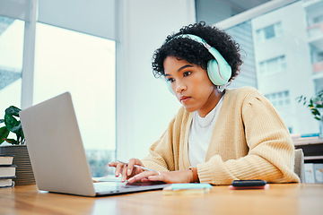 Image showing Headphones, laptop and young woman typing for research in living room listening to music, playlist or album. Technology, computer and female person from Colombia streaming song on radio for studying.