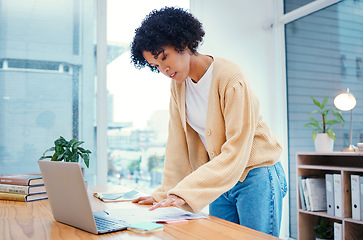 Image showing Woman with laptop, documents and standing in office with admin, internet and creative ideas for freelance project. Remote work, reading paperwork and girl with computer, research and notes for agenda