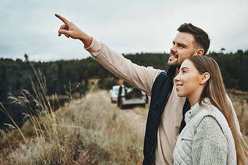 Image showing Couple, hiking and pointing on mountain for road trip, vacation or outdoor adventure together in nature. Happy man and woman smile for trekking, holiday vacation or travel on journey or showing path