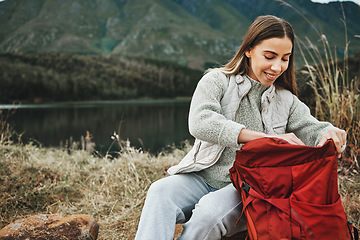 Image showing Nature, backpack and young woman hiking on a mountain for adventure, weekend trip or vacation. Happy, bag and female person from Canada trekking and camping in an outdoor forest or woods for holiday.