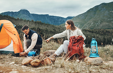 Image showing Couple, camping and set up tent in nature for vacation, holiday and travel together. Campsite, man and woman outdoor in preparation for adventure, hiking and trekking in the countryside for freedom