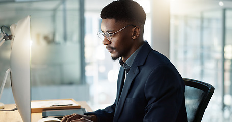 Image showing Thinking, businessman and reading on computer with a smile in office for email, feedback or communication. Working, online or black man with research, inspiration or ideas from Nigeria report or news