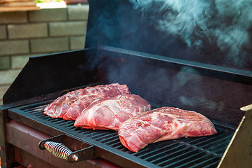 Image showing Pork meat steaks on the grill