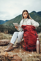 Image showing Woman, hiking and tablet with backpack in nature for check, ready and thinking by hill, mountains and outdoor. Girl, luggage and trekking with bag, technology and ideas on adventure in countryside