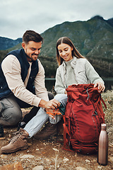 Image showing Couple, hiking and packing backpack in nature with smile, check and thinking by hill, mountains and outdoor. Man, woman and luggage for trekking, happy and ideas on fitness adventure in countryside