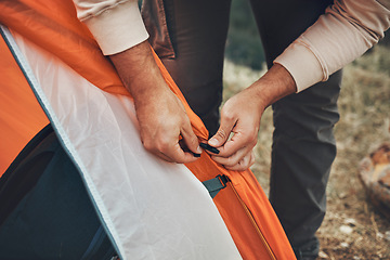 Image showing Hands, pitch tent and camping in nature on vacation, holiday or travel outdoor. Campsite, closeup and man set up shelter, tying and preparation for adventure, hiking or trekking in woods for freedom