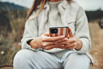 Image showing Nature, hands and closeup of woman on a phone networking on social media, mobile app or the internet. Technology, mountain and female person typing a text message on cellphone in the countryside.