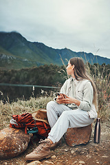 Image showing Camping, phone and woman relax in nature with social media, freedom or outdoor peace. Hiking, break and female explorer with smartphone, app or chat while chilling at forest lake and enjoying scenery