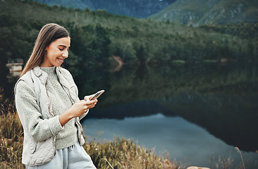 Image showing Woman, phone and nature, mountains or lake with social media, network and internet connection for travel. Happy person on mobile, chat and search for outdoor location, carbon footprint blog and space
