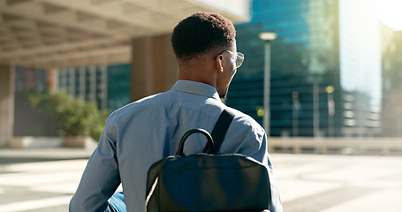 Image showing City, back and business person walking on outdoor urban journey, commute and businessman on way to office building. Backpack, morning and professional agent on morning travel to work in Chicago, USA