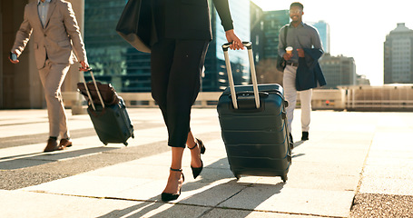 Image showing Business, legs and luggage for travel in city with corporate people walking to hotel, airport or business opportunity. Professional woman or men feet and steps with suitcase outdoor in career journey