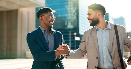 Image showing Outdoor, men and walking with business people, handshake and planning with smartphone, smile and hug. Staff, city and coworkers with feedback, speaking and cooperation with professional and talking