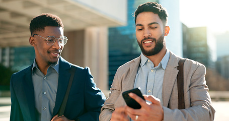 Image showing Outdoor, men and walking with business people, smartphone and planning with social media. Staff, city and cellphone with feedback, speaking and cooperation with professional, digital app and smile