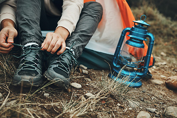 Image showing Shoes, hands tie shoelace and camping, person outdoor in nature for travel and adventure, explore and lamp. Boots, hiking with start or prepare for walk, trekking and journey with health and fitness