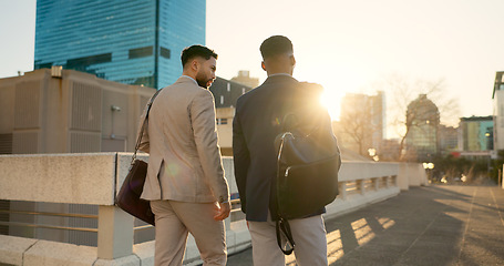 Image showing Business, men and walking in street with support in city for partnership, collaboration and teamwork. Professional, people and outdoor by buildings for travel, commute and conversation and diversity