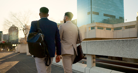 Image showing Business, men and walking in street with support in city for partnership, collaboration and teamwork. Professional, people and outdoor by buildings for travel, commute and conversation and diversity