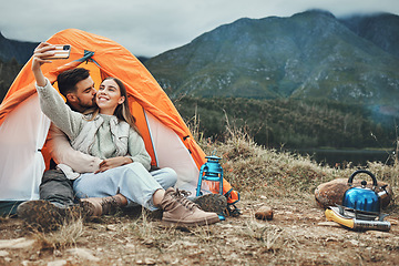 Image showing Couple, tent and kiss in camping selfie, memory and holiday on web blog, morning and countryside. Man, woman and relax with vacation, social network post and adventure with love, outdoor and freedom