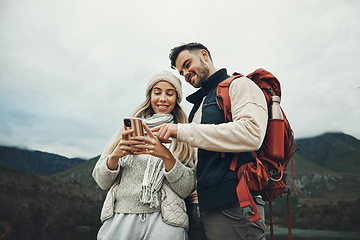 Image showing Couple, phone and travel in nature or mountains with hiking information, social media or check for direction on journey. Happy people trekking in backpack, mobile chat or search for outdoor location