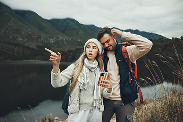 Image showing Hiking, stress and lost couple with a phone in nature for direction, map or navigation with anxiety. Backpacking, travel and people with smartphone app for location search or navigation to campsite