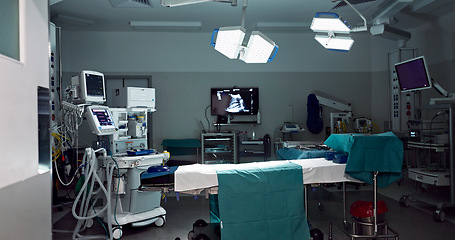 Image showing Empty, dark hospital and room for operation, emergency service and healing patient. Healthcare backgrounds, surgery theatre and interior of bed, machine and medical tools for wellness, help and risk