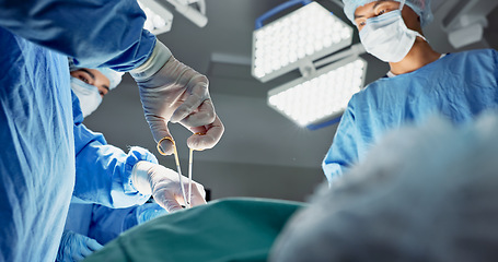 Image showing Doctors, team and scissors in theater for surgery, healthcare or medical support and operation room at hospital. Surgeon, medicine and teamwork or collaboration with tools for cardiology or emergency