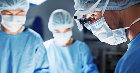 Image showing Surgery, hospital and doctor with face mask for operation, medical emergency and service in theater. Healthcare, procedure and closeup of surgeon with light for patient injury, wellness and accident