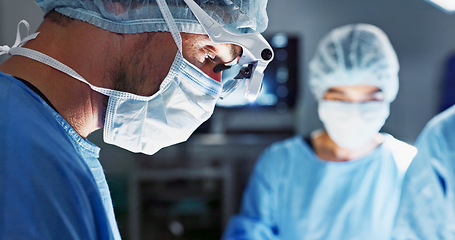 Image showing Surgery, hospital and doctor with face mask for operation, medical emergency and service in theater. Healthcare, procedure and closeup of surgeon with light for patient injury, wellness and accident