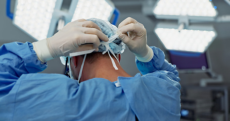 Image showing Surgery, prepare and doctor tie mask in operating room for medical service, protection and operation. Healthcare team, safety scrubs and person with uniform for emergency, procedure and wellness