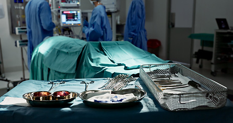 Image showing Surgery, healthcare and tools in operation theatre, help in medicine with treatment and closeup of equipment on table. Metal, medical and surgical instrument with doctor people at hospital for health