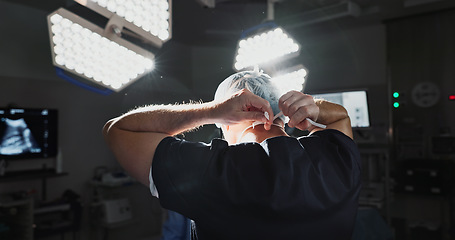 Image showing Surgery, prepare and doctor tie mask in operating room for medical service, protection and operation. Healthcare team, safety scrubs and person with uniform for emergency, procedure and wellness