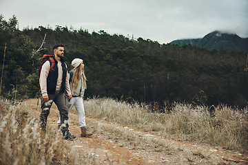 Image showing Couple walking, hiking and nature with travel, mountain and backpacking with wilderness and explore outdoor. People holding hands, adventure and holiday with date, environment and trekking path