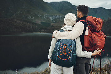 Image showing Couple, back with hiking and nature view with travel, mountain and backpacking with wilderness and explore outdoor. People on adventure, holiday with anniversary date and environment with trekking