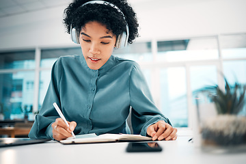 Image showing Headphones, notebook and businesswoman writing notes in the office doing research for creative project. Schedule, professional and female designer work, plan and listen to music in modern workplace.