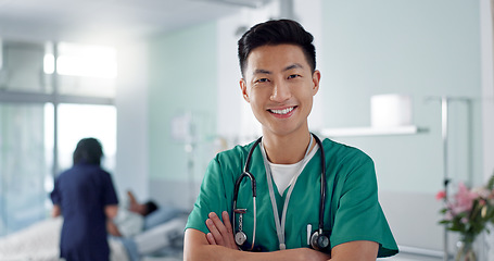 Image showing Face, happy nurse and Asian man with arms crossed in hospital for healthcare, wellness and medicine. Portrait, smile and confident medical worker, professional surgeon and expert employee in clinic