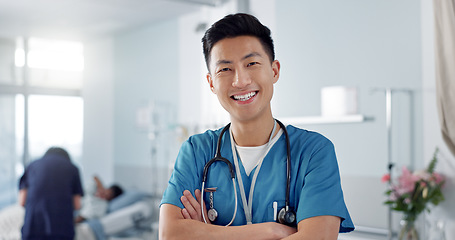 Image showing Healthcare, doctor and asian man with arms crossed at hospital with smile for support, service and wellness. Medicine, professional and expert with happiness and pride for career, surgery or care