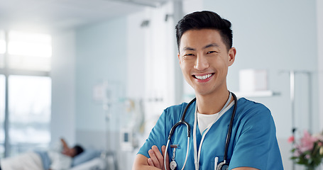 Image showing Medicine, doctor and asian man with arms crossed at hospital with smile for support, service and wellness. Healthcare, professional or expert with happiness and pride for career, surgery or insurance