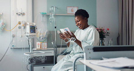 Image showing Woman, reading card and bed in hospital for message, get well soon or motivation with smile, hope and recovery. Patient, excited and gratitude for kindness, love or quote with gift for rehabilitation