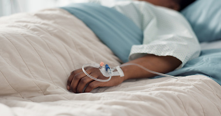 Image showing Healthcare, hand and iv with a patient in a hospital bed for recovery or rehabilitation closeup. Medical, wellness and treatment with a sick person lying in a clinic on a saline solution drip