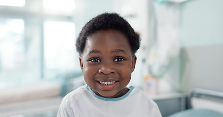 Image showing Face, smile and a boy child patient in the hospital to visit a pediatrician for healthcare or a medical checkup. Portrait, medicine and a happy young african kid in a clinic for treatment or cure