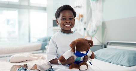 Image showing Healthcare, black child and teddy bear in hospital for surgery recovery, patient and healthy results. Face, boy kid and bed for medical, wellness or toy for relax on bed, rehabilitation and happiness