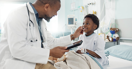 Image showing Doctor, African boy kid and hospital with tablet, smile and rest for recovery from surgery, treatment or inspection. Child patient, medic and check with touchscreen, talk and rehabilitation in clinic