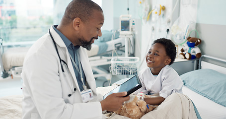 Image showing Doctor, African boy child and hospital with tablet, smile or rest for recovery from surgery, consulting or inspection. Kid, happy and medic for check, touchscreen or talk in clinic for rehabilitation
