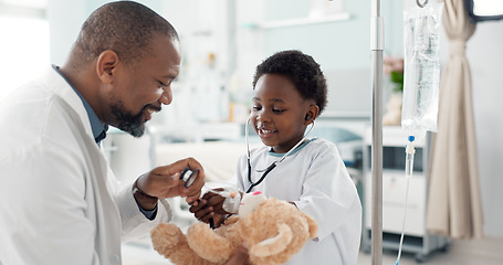 Image showing Doctor, African kid and stethoscope for teddy bear, smile or play for recovery from surgery, game or breathing. Child patient, medic and boy with toys, talk or consulting for rehabilitation in clinic