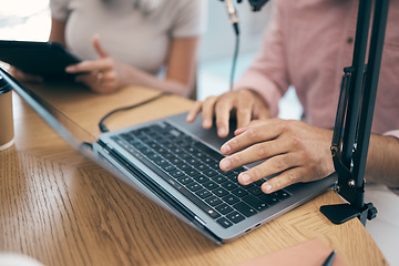 Image showing Radio, hands and technology with teamwork for podcast, content creation and planning with laptop or tablet. Talk show, man and woman in studio with equipment for collaboration with broadcast or media