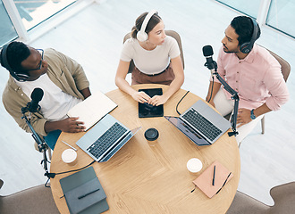 Image showing Laptop, podcast or broadcast with a content creator team in their office from above for streaming or recording. Radio, microphone and influencer friends in the studio together on a creative platform