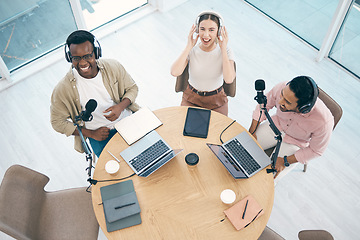 Image showing Radio, podcast or broadcast with a content creator team in their office from above for streaming or recording. Laptop, microphone and influencer friends in the studio together on a creative platform