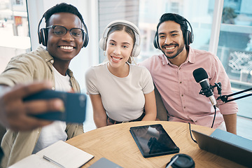 Image showing Podcast, happy and group selfie of friends together, live streaming or people recording broadcast in studio. Team of radio hosts take photo at table for social media blog on headphones or microphone