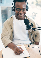 Image showing Live stream, podcast or black man with notebook, microphone or headphones with news broadcasting. Smile, African person or radio presenter with tech, public relations or writing with content creator